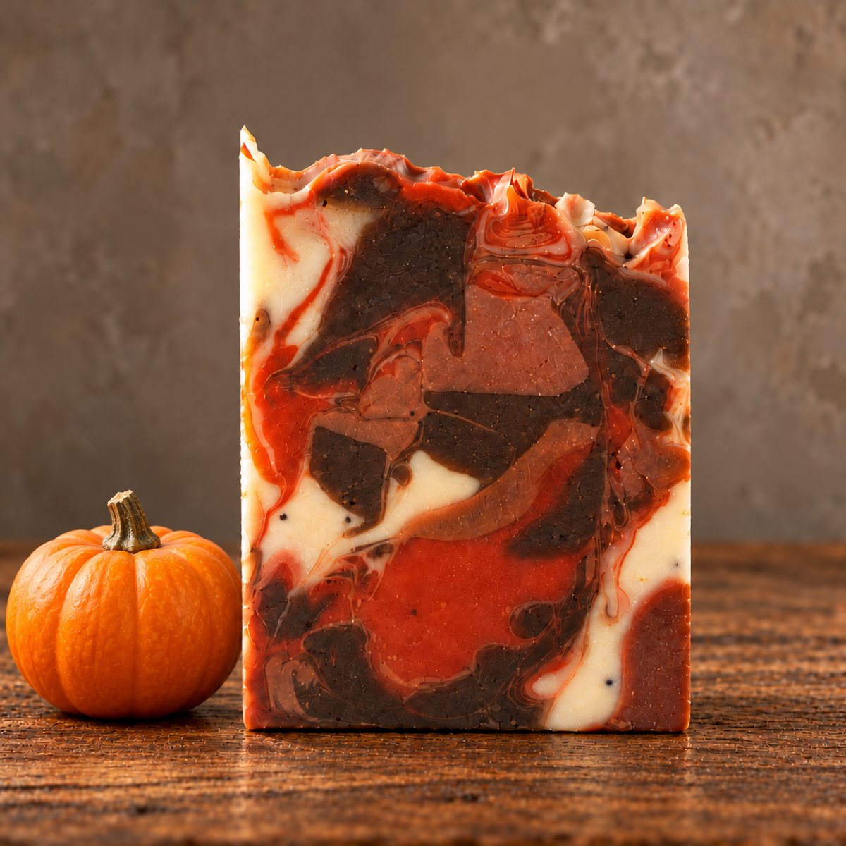 Harvest Pumpkin Handmade Soap in a rustic indoor setting with ingredient accents