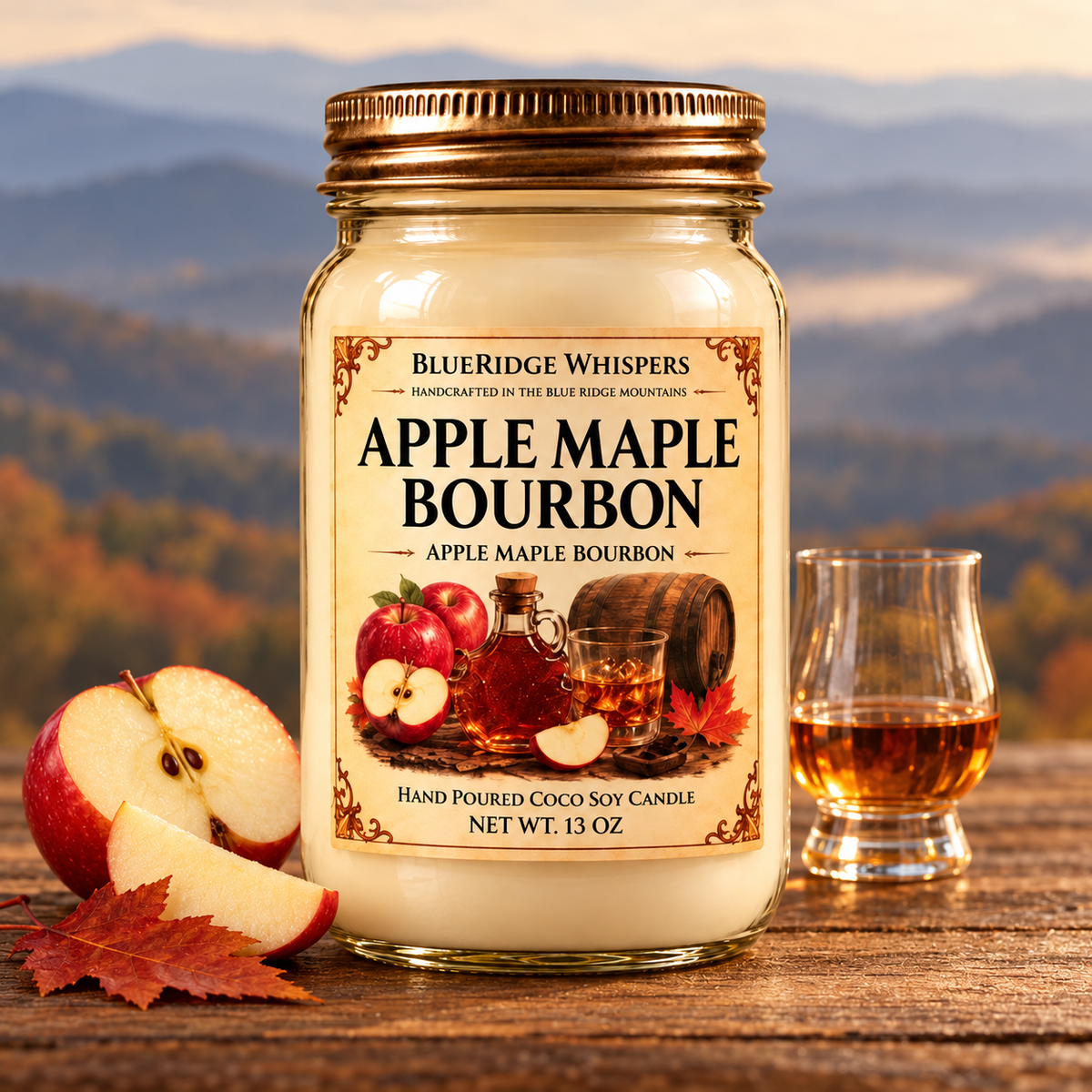 Apple Maple Bourbon candle on rustic wood with apple, maple leaf and bourbon accents, with softly blurred Blue Ridge mountains.