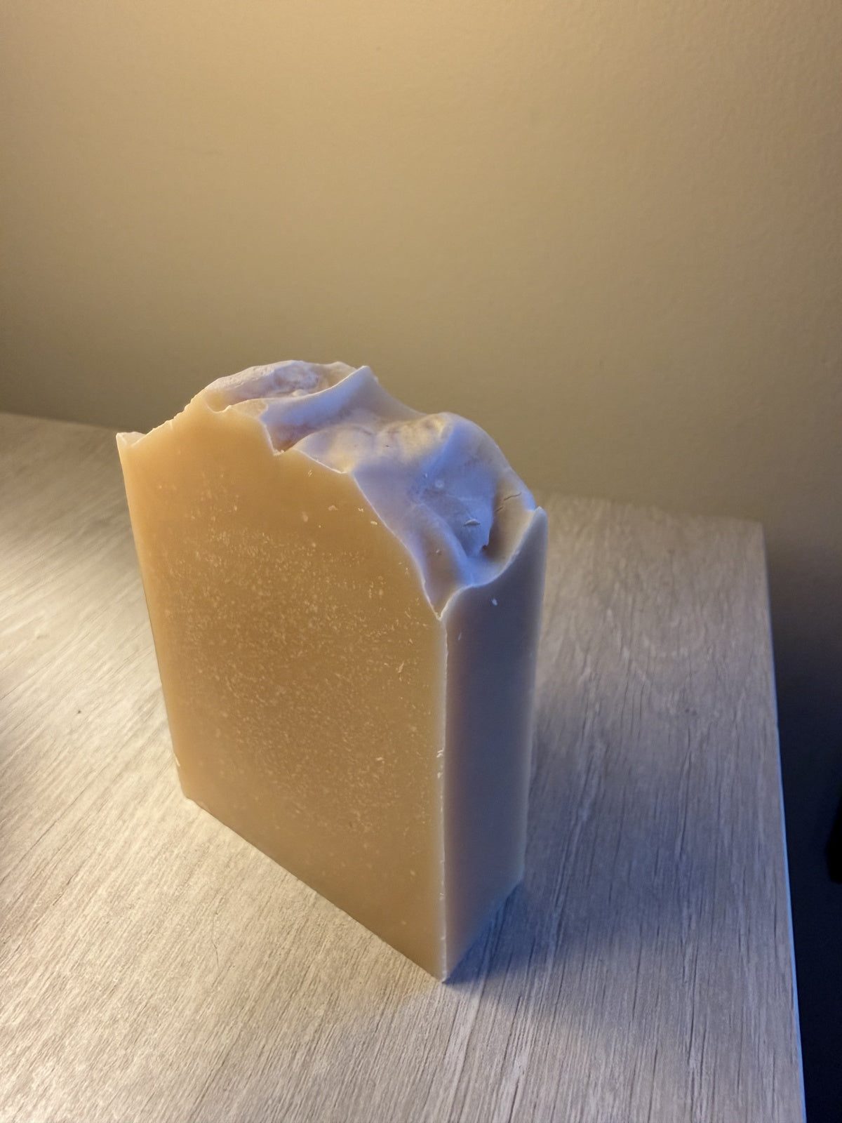 Original photograph of Mountain Milk soap showing its natural cream color, fine speckles, and textured top.