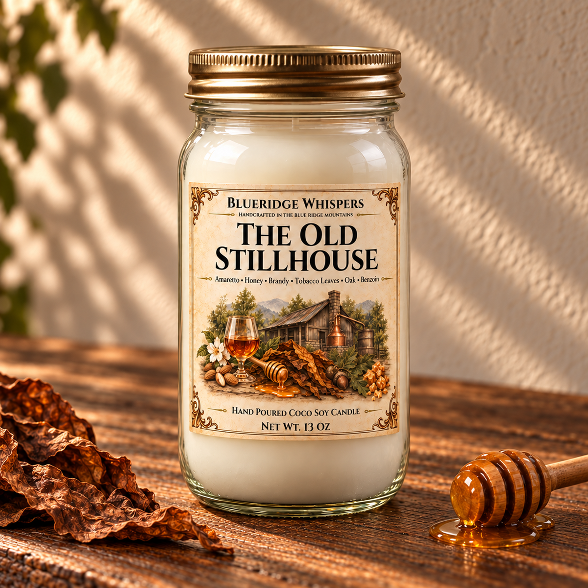 The Old Stillhouse – Tobacco & Honey Coco-Soy Candle on a dark rustic wooden table with scent accents in warm natural light.